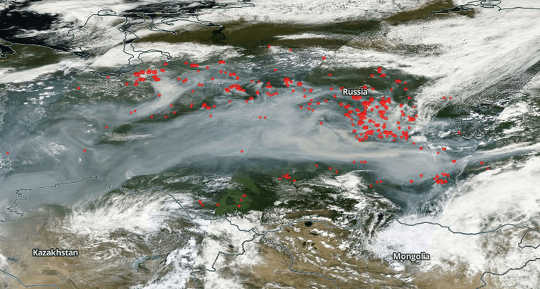 Red dots represent fires in Siberia on July 22, with smoke extending thousands of kilometres to the west. NASA Worldview
